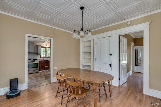 25 Waid St, Gouverneur, NY 13642 - dining area with a chandelier, light wood finished floors, baseboards, and an ornate ceiling