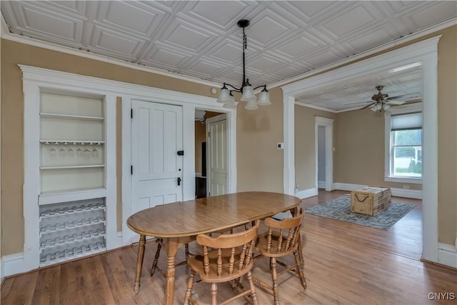 25 Waid St, Gouverneur, NY 13642 - dining space with built in shelves, wood finished floors, baseboards, and a ceiling fan
