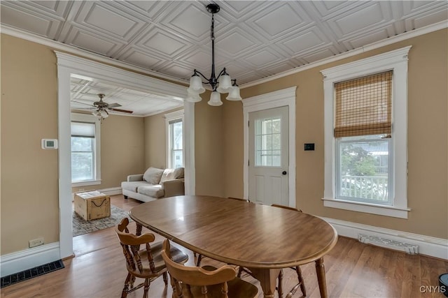 25 Waid St, Gouverneur, NY 13642 - dining room featuring wood finished floors, a chandelier, and baseboards