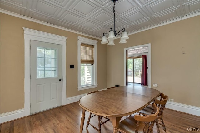 25 Waid St, Gouverneur, NY 13642 - dining space with a chandelier, baseboards, light wood-style floors, and an ornate ceiling
