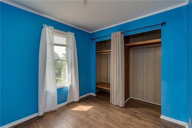 25 Waid St, Gouverneur, NY 13642 - unfurnished bedroom with crown molding, wood finished floors, and baseboards