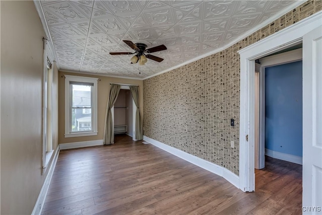 25 Waid St, Gouverneur, NY 13642 - empty room with crown molding, an ornate ceiling, a ceiling fan, baseboards, and wood finished floors