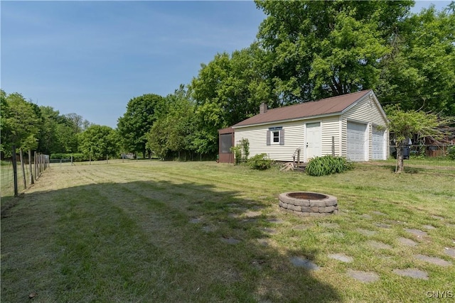 25 Waid St, Gouverneur, NY 13642 - view of yard with an outdoor fire pit, an outbuilding, and a garage