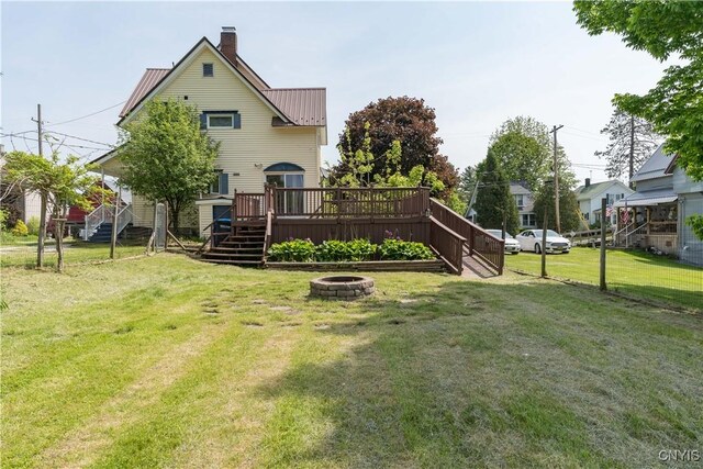 25 Waid St, Gouverneur, NY 13642 - back of property with stairs, a wooden deck, a chimney, and a lawn
