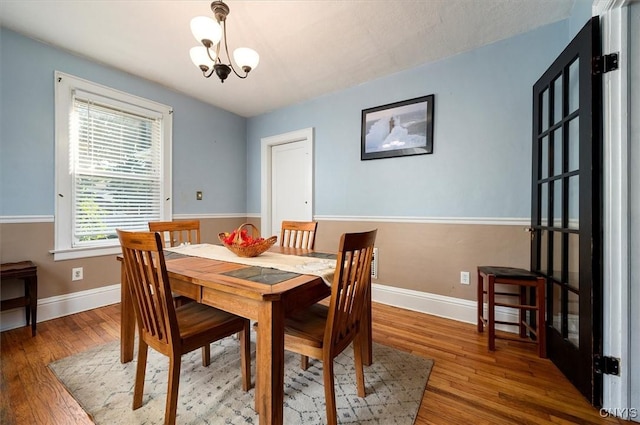 817 Mildred Ave, Utica, NY 13502 - dining space featuring wood finished floors, a chandelier, and baseboards