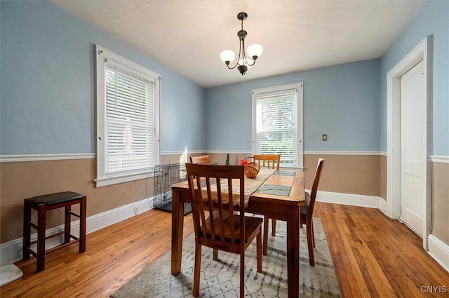 817 Mildred Ave, Utica, NY 13502 - dining area featuring hardwood / wood-style flooring, a chandelier, and baseboards