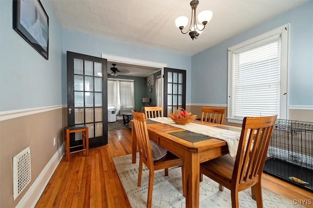 817 Mildred Ave, Utica, NY 13502 - dining room with hardwood / wood-style flooring, baseboards, french doors, and a chandelier