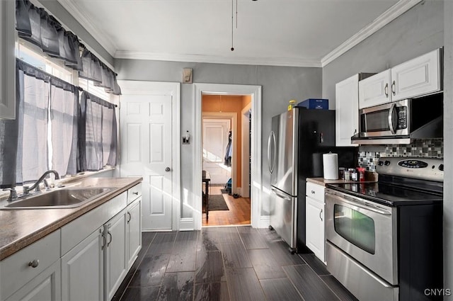 817 Mildred Ave, Utica, NY 13502 - kitchen with stainless steel appliances, a sink, white cabinetry, crown molding, and backsplash