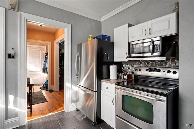 817 Mildred Ave, Utica, NY 13502 - kitchen featuring appliances with stainless steel finishes, tasteful backsplash, white cabinets, baseboards, and crown molding