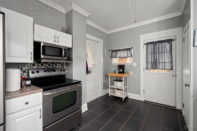 817 Mildred Ave, Utica, NY 13502 - kitchen featuring stainless steel appliances, tasteful backsplash, baseboards, white cabinetry, and crown molding