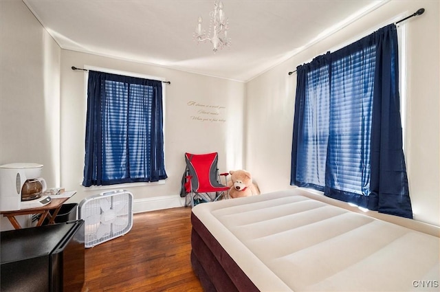 817 Mildred Ave, Utica, NY 13502 - bedroom featuring wood finished floors, a chandelier, and baseboards