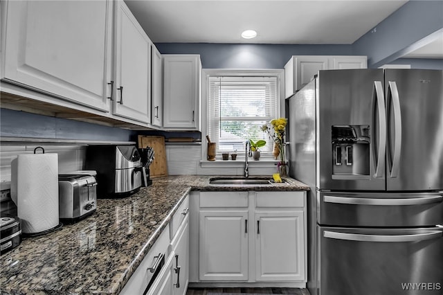 126 Midland Dr, Cheektowaga, NY 14225 - kitchen featuring stainless steel refrigerator with ice dispenser, a sink, white cabinetry, dark stone countertops, and recessed lighting