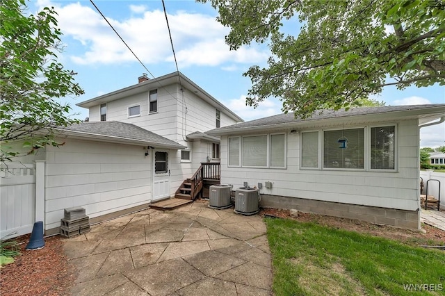 27 Lynn Lea St, Amherst, NY 14221 - rear view of house featuring central air condition unit, a patio area, and roof with shingles