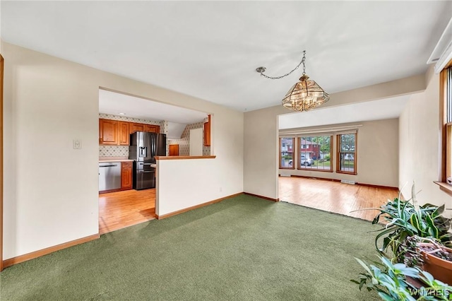27 Lynn Lea St, Amherst, NY 14221 - unfurnished living room featuring light carpet, a chandelier, and baseboards