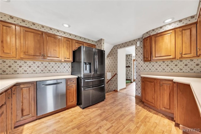 27 Lynn Lea St, Amherst, NY 14221 - kitchen featuring appliances with stainless steel finishes, wallpapered walls, light wood-style flooring, brown cabinets, and light countertops