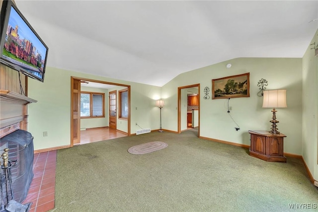 27 Lynn Lea St, Amherst, NY 14221 - unfurnished living room with baseboards, carpet floors, vaulted ceiling, and a fireplace