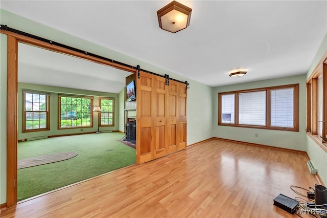 27 Lynn Lea St, Amherst, NY 14221 - unfurnished room with a barn door, baseboards, and wood finished floors