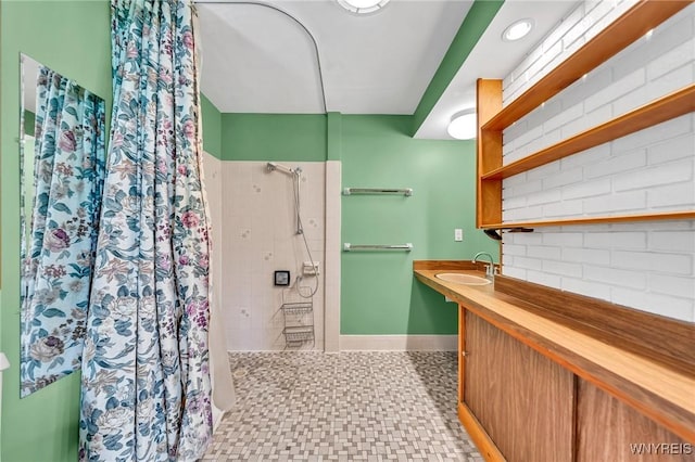 27 Lynn Lea St, Amherst, NY 14221 - full bathroom featuring a shower with shower curtain, vanity, baseboards, backsplash, and tile patterned floors