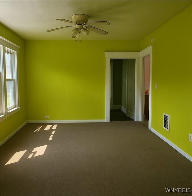 472 Leroy Ave, Buffalo, NY 14215 - empty room featuring a ceiling fan and dark carpet