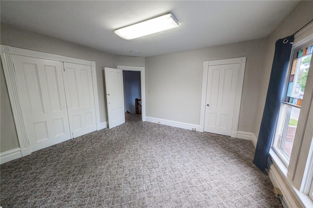 5 Gansevoort St, Bath, NY 14810 - unfurnished bedroom featuring multiple windows, carpet flooring, baseboards, and a closet