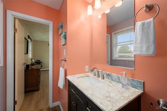 1 Christopher Cir, New Hartford, NY 13413 - bathroom with vanity, baseboards, a baseboard heating unit, and wood finished floors