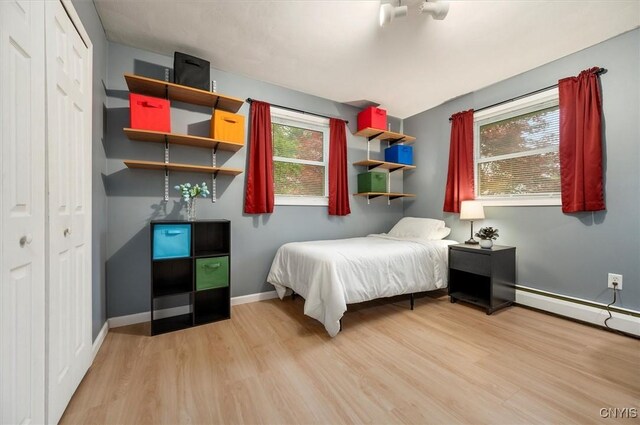 1 Christopher Cir, New Hartford, NY 13413 - bedroom with light wood finished floors, a closet, and baseboards