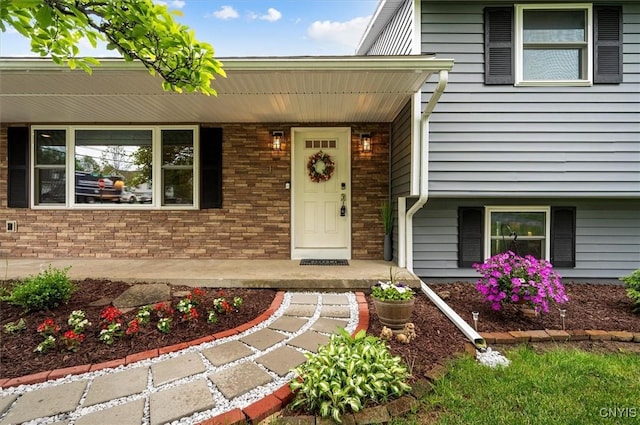 1 Christopher Cir, New Hartford, NY 13413 - doorway to property featuring a porch and brick siding
