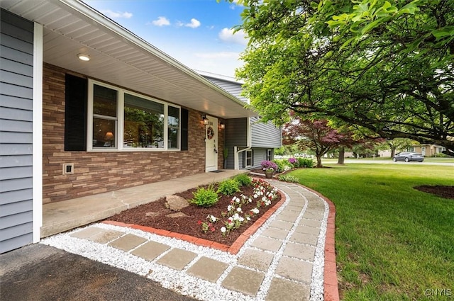 1 Christopher Cir, New Hartford, NY 13413 - property entrance featuring a lawn, brick siding, and covered porch