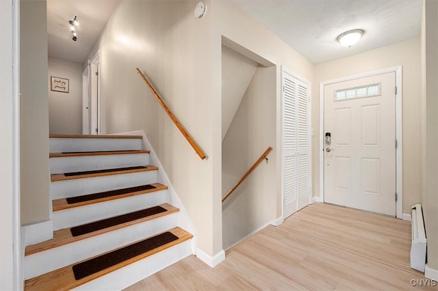 1 Christopher Cir, New Hartford, NY 13413 - foyer with wood finished floors, baseboards, and a baseboard heating unit