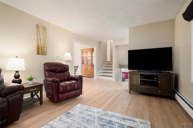 1 Christopher Cir, New Hartford, NY 13413 - living room with light wood-style flooring, stairs, a baseboard radiator, and baseboards