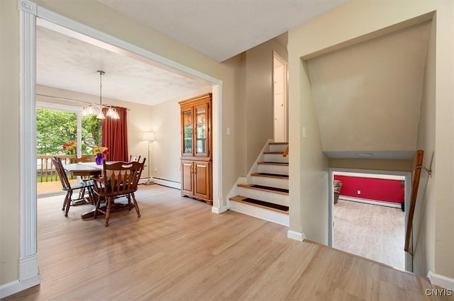 1 Christopher Cir, New Hartford, NY 13413 - dining area featuring wood finished floors, a chandelier, stairway, baseboards, and baseboard heating