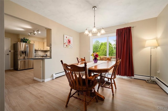 1 Christopher Cir, New Hartford, NY 13413 - dining space with a baseboard heating unit, a chandelier, and light wood finished floors