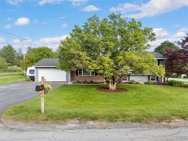 1 Christopher Cir, New Hartford, NY 13413 - view of property hidden behind natural elements featuring an attached garage, asphalt driveway, a front yard, and brick siding