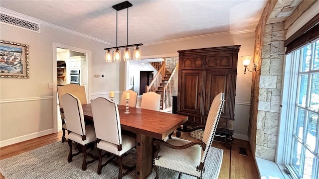 11 Sunrise Park, Pittsford, NY 14534 - dining area featuring wood finished floors, ornamental molding, stairs, and baseboards