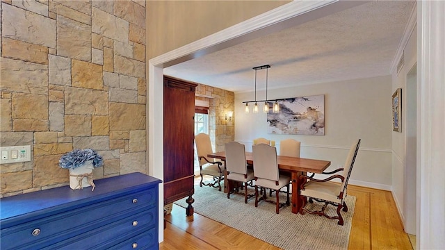11 Sunrise Park, Pittsford, NY 14534 - dining space with a textured ceiling, crown molding, and light wood-style floors