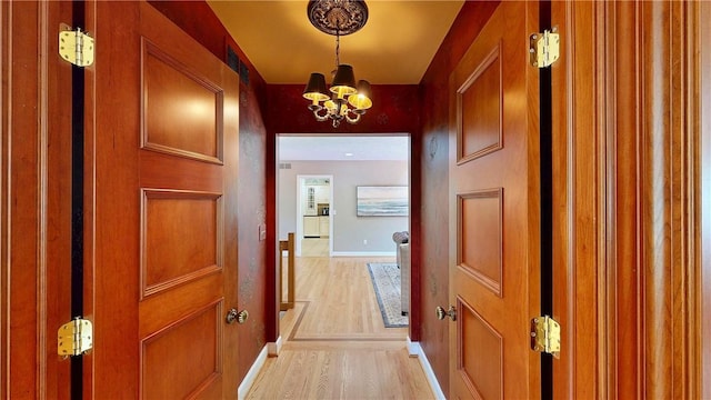 11 Sunrise Park, Pittsford, NY 14534 - hall with baseboards, light wood-style floors, and a chandelier