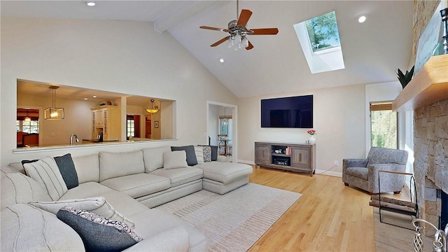 11 Sunrise Park, Pittsford, NY 14534 - living room with high vaulted ceiling, beam ceiling, wood finished floors, ceiling fan, and a skylight