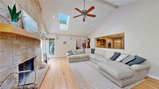 11 Sunrise Park, Pittsford, NY 14534 - living room with high vaulted ceiling, a ceiling fan, wood finished floors, a stone fireplace, and beamed ceiling