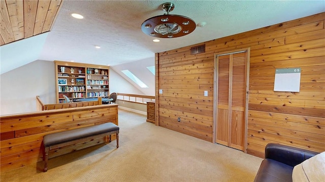 11 Sunrise Park, Pittsford, NY 14534 - living area featuring wooden walls, carpet, recessed lighting, a skylight, and lofted ceiling