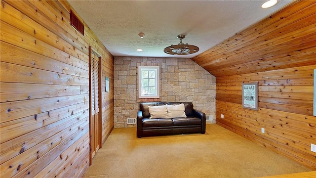 11 Sunrise Park, Pittsford, NY 14534 - sitting room featuring wooden walls, carpet flooring, lofted ceiling, and a textured ceiling
