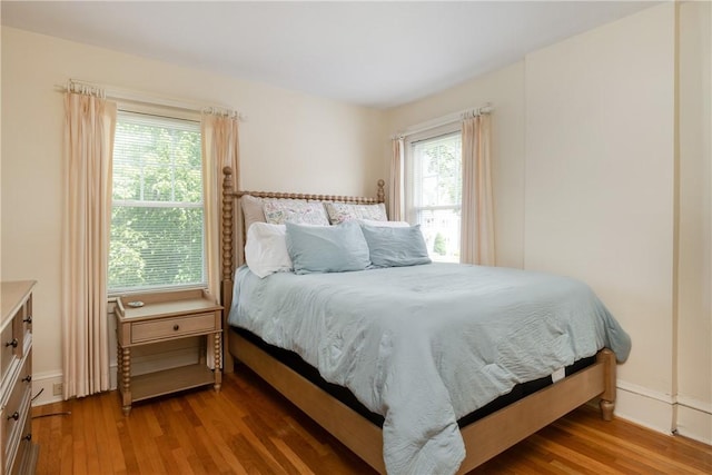 39 Sunnyside Dr, Elmira, NY 14905 - bedroom with wood finished floors, multiple windows, and baseboards