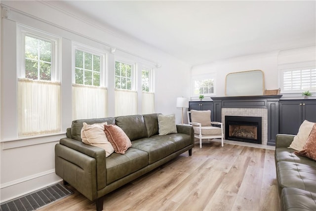 39 Sunnyside Dr, Elmira, NY 14905 - living room with a brick fireplace, light wood-type flooring, and baseboards