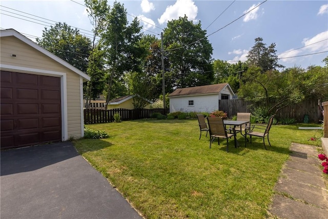 39 Sunnyside Dr, Elmira, NY 14905 - view of yard with an outbuilding, a garage, and asphalt driveway
