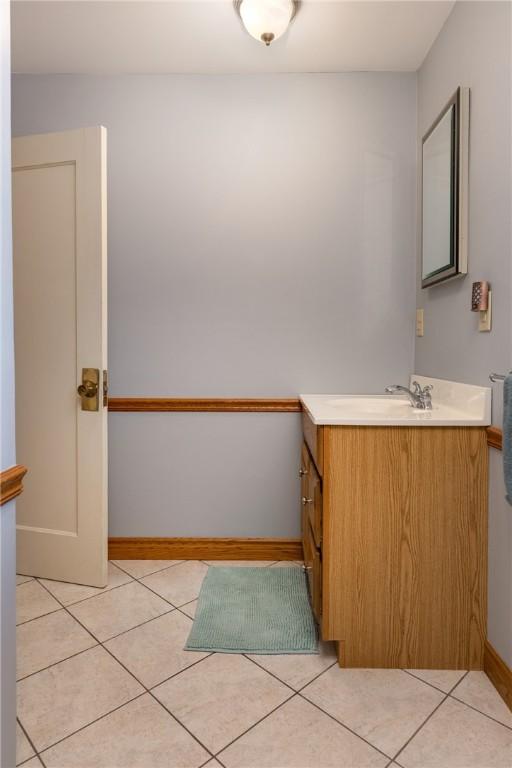 39 Sunnyside Dr, Elmira, NY 14905 - bathroom with vanity, tile patterned flooring, and baseboards