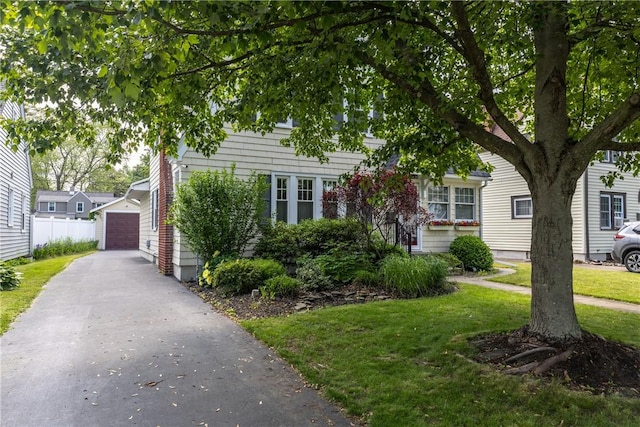39 Sunnyside Dr, Elmira, NY 14905 - view of property hidden behind natural elements featuring a front yard, a detached garage, and an outbuilding