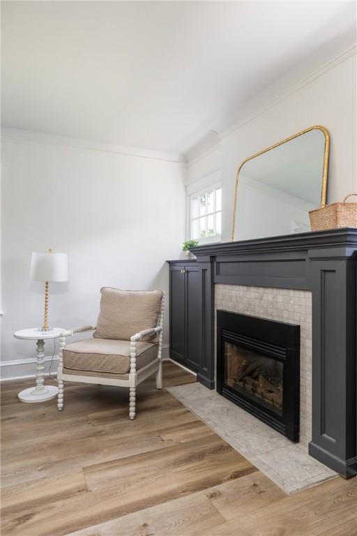 39 Sunnyside Dr, Elmira, NY 14905 - sitting room featuring ornamental molding, light wood-type flooring, a tile fireplace, and baseboards