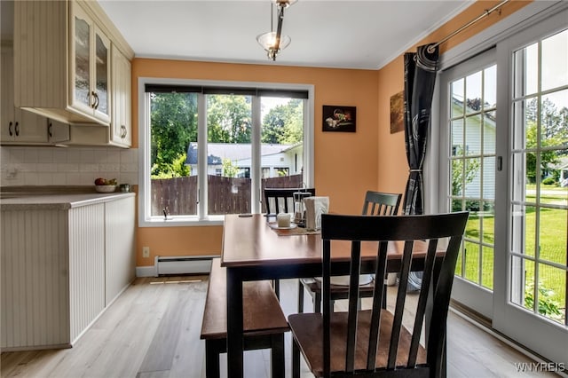 669 Quaker Rd, Aurora, NY 14052 - dining room with baseboard heating, healthy amount of natural light, and light wood-style flooring