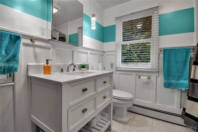 669 Quaker Rd, Aurora, NY 14052 - full bath featuring a decorative wall, baseboard heating, vanity, a wainscoted wall, and toilet