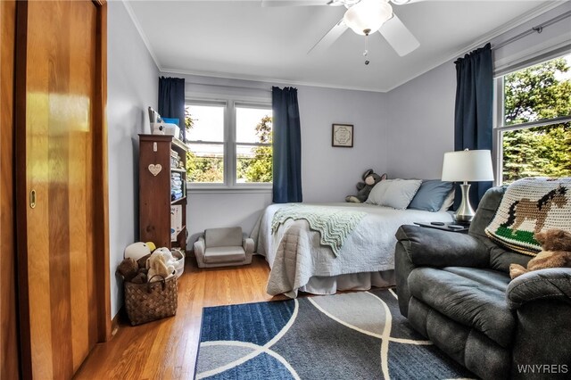 669 Quaker Rd, Aurora, NY 14052 - bedroom featuring multiple windows, wood finished floors, ornamental molding, and ceiling fan