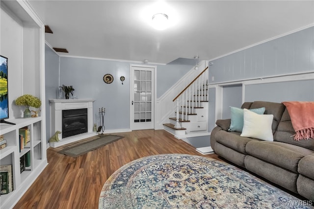 669 Quaker Rd, Aurora, NY 14052 - living room featuring wood finished floors, crown molding, stairs, and a glass covered fireplace